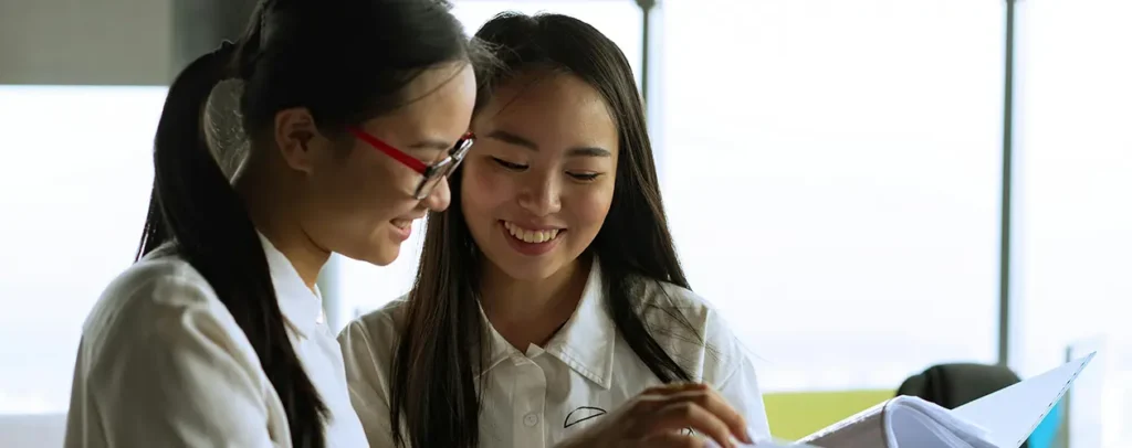 Women looking at a binder